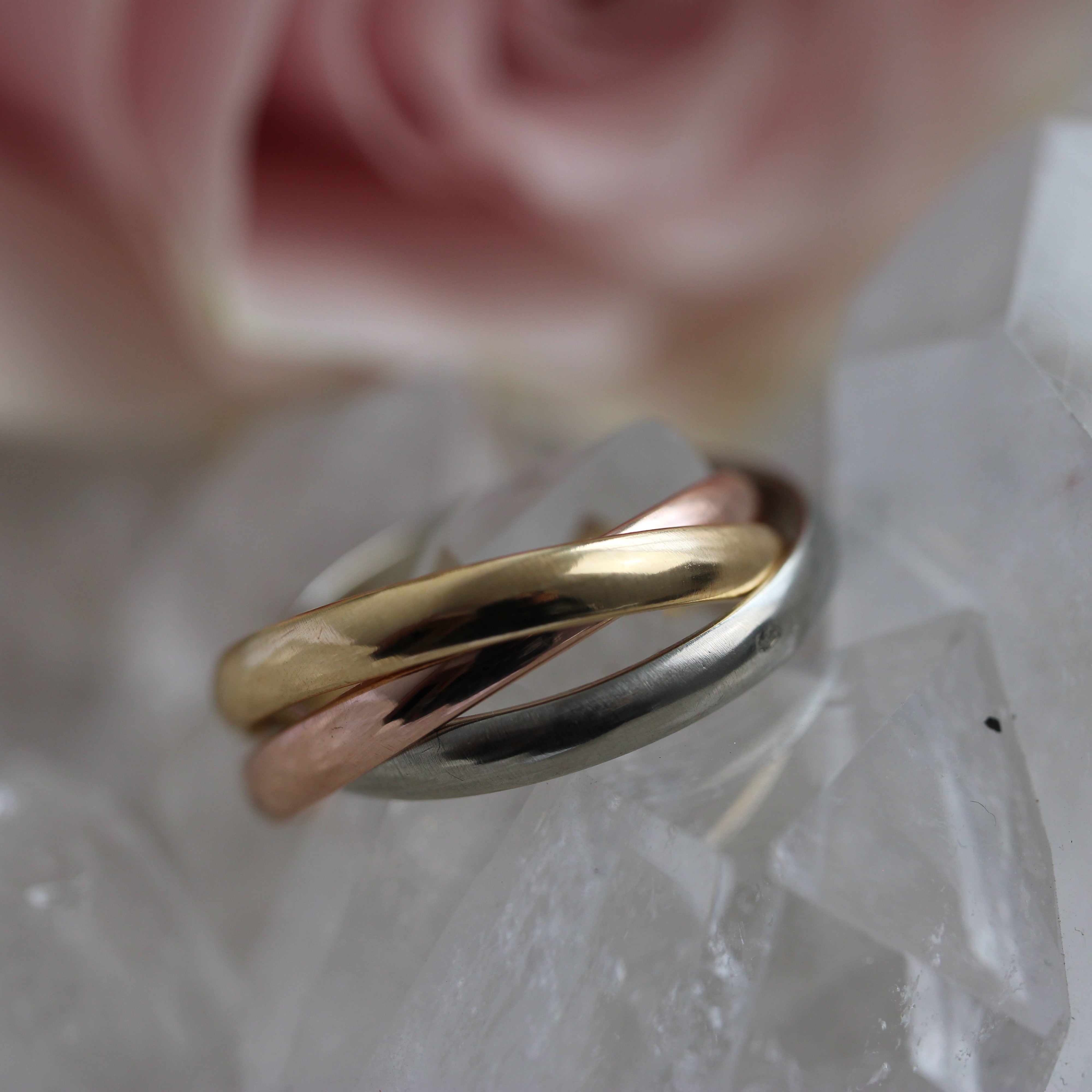 Gold and silver ring on a crystal surface