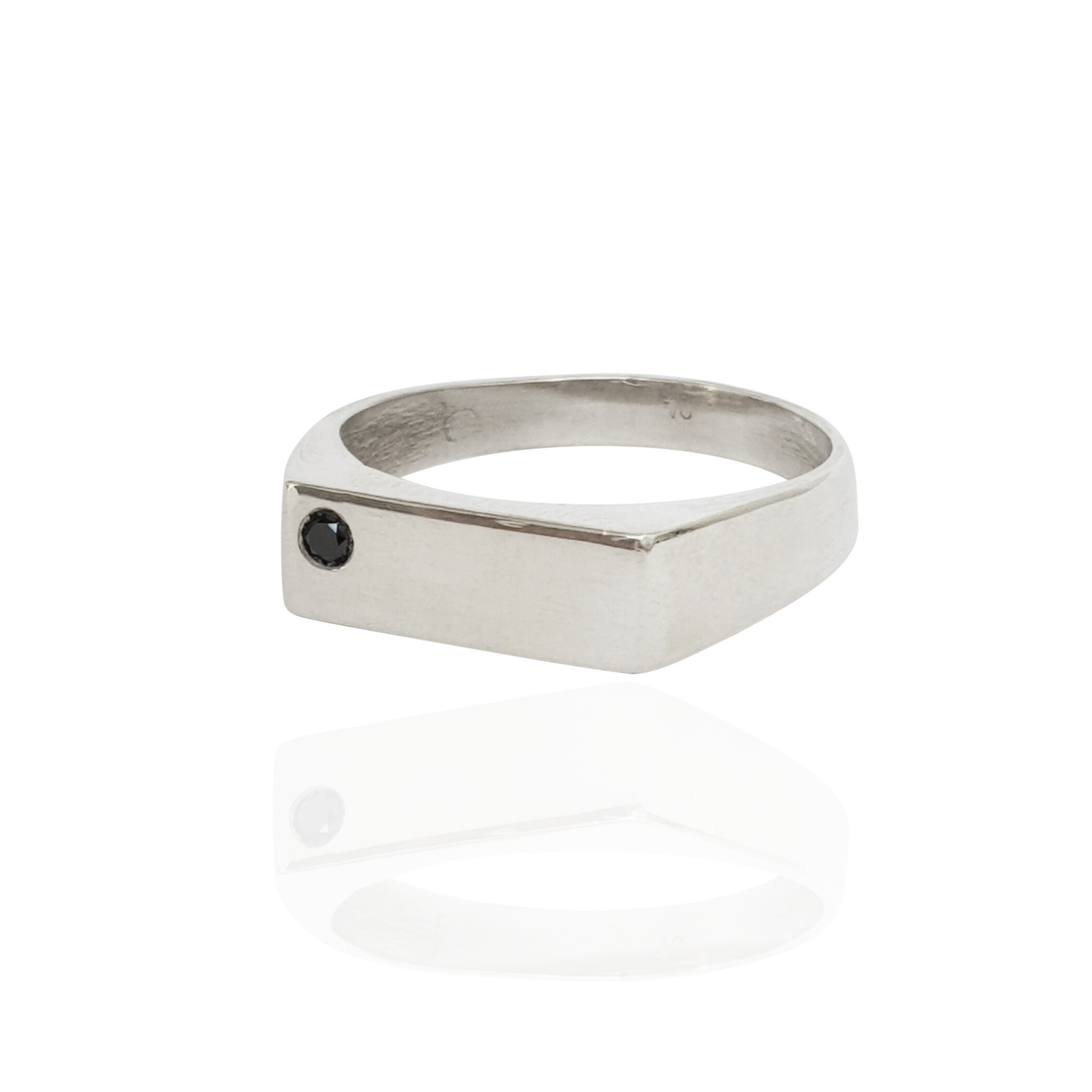 Silver ring with a black gemstone on a white background