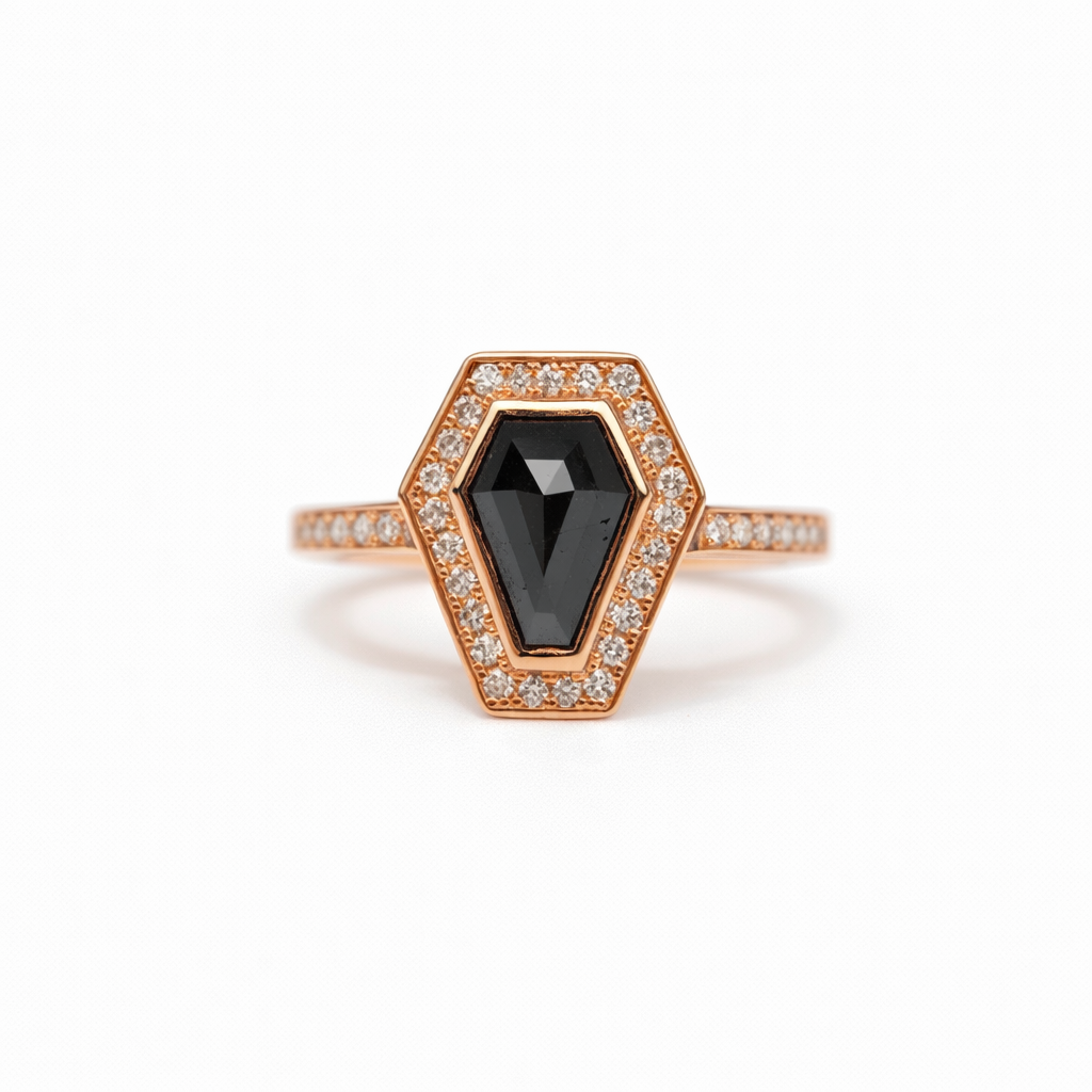 Rose gold ring with a black gemstone and diamond accents on a white background