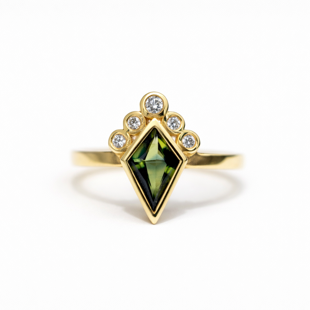 Gold ring with a green gemstone on a white background