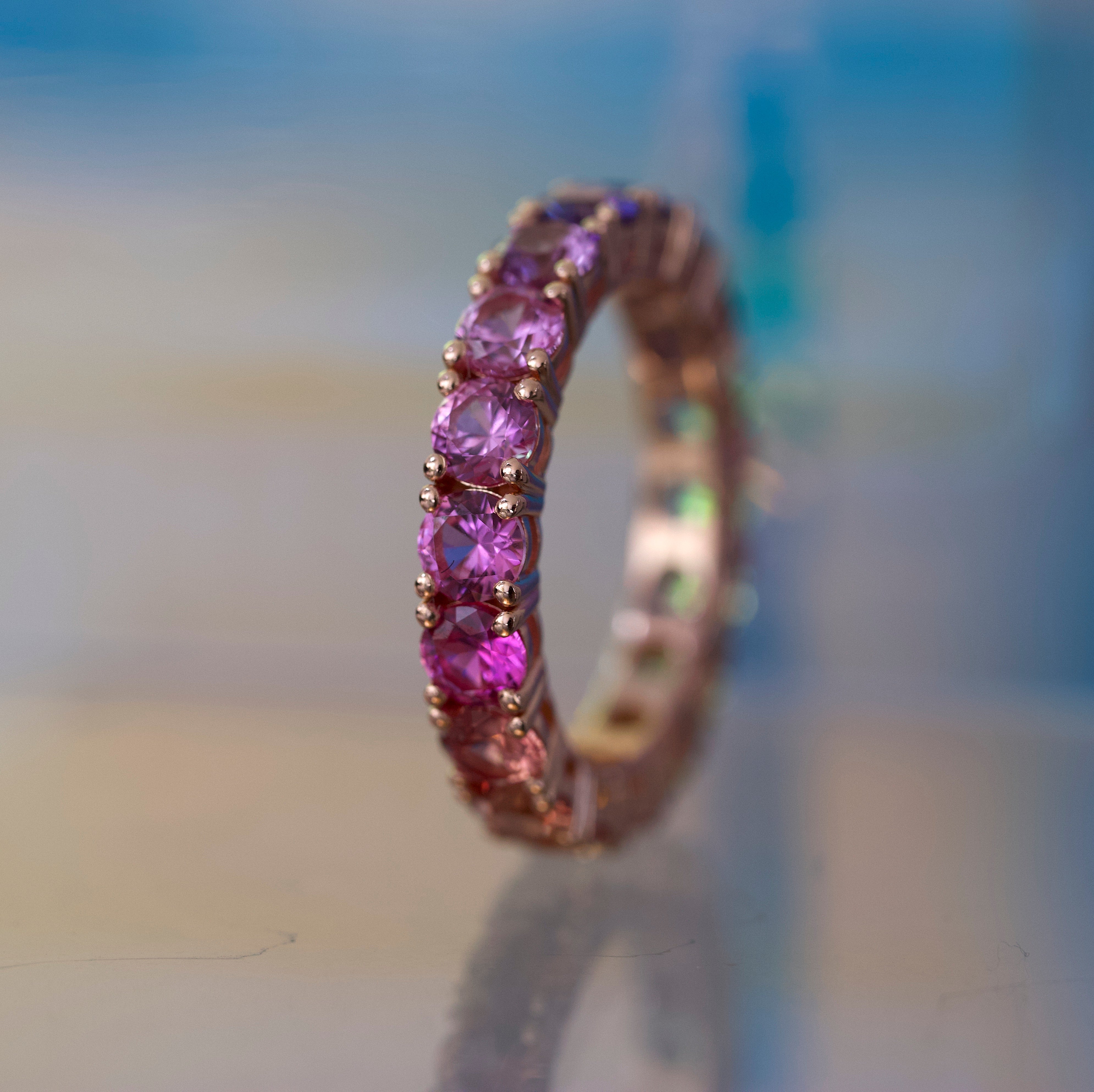 Close-up of a ring with purple gemstones on a blurred background