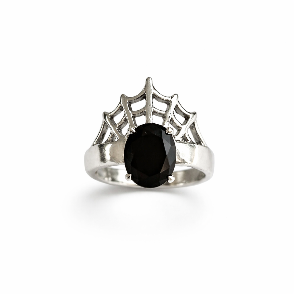 Silver ring with a spider web with a black gemstone on a white background
