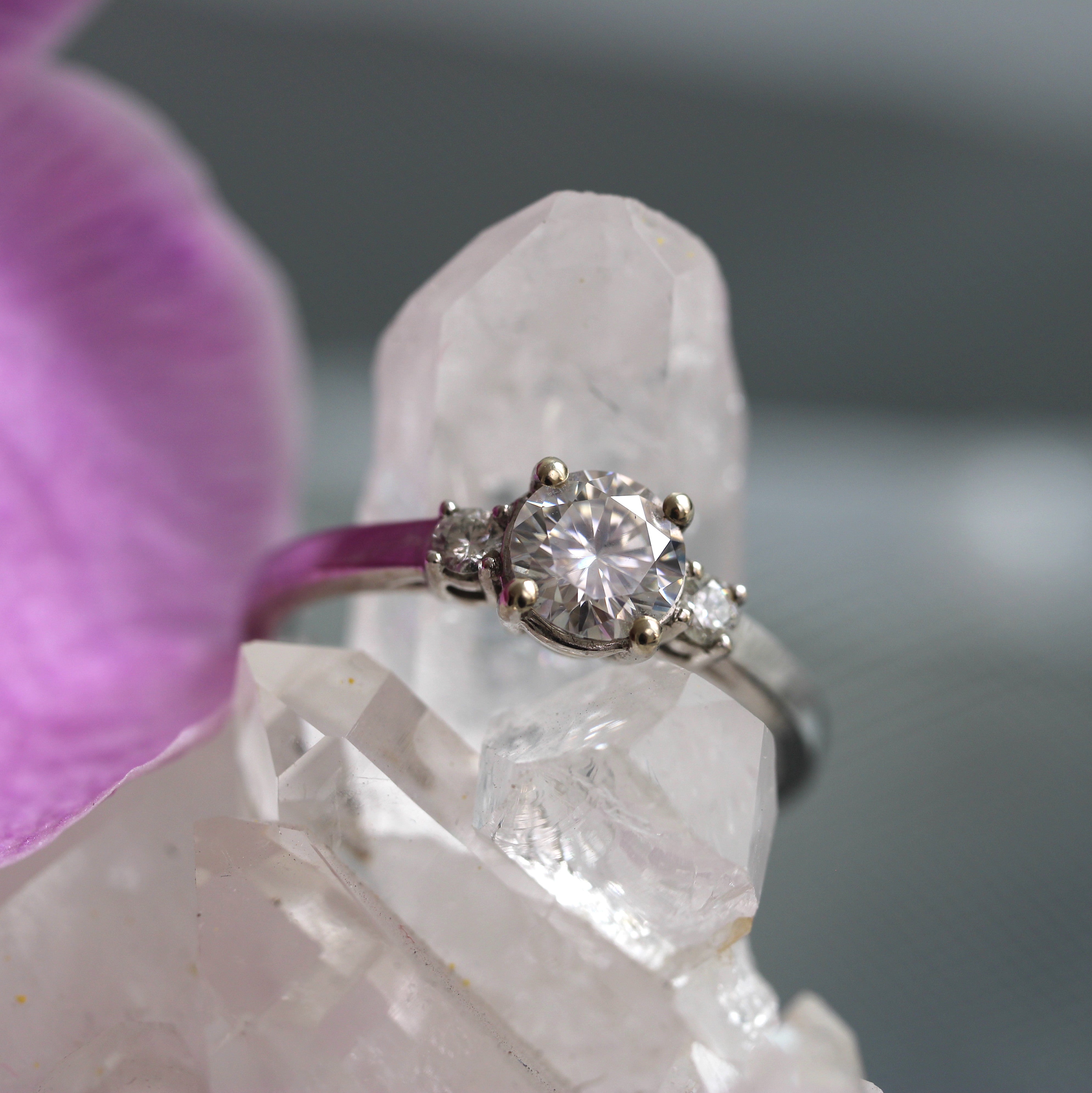 Round moissanite engagement ring in 10ct white gold with diamond accents