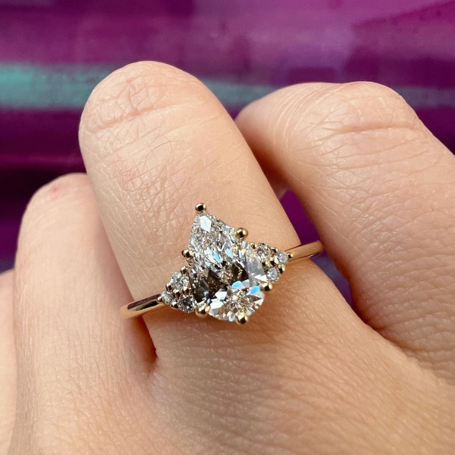 Alternative engagement ring with salt and pepper diamond in pear shape