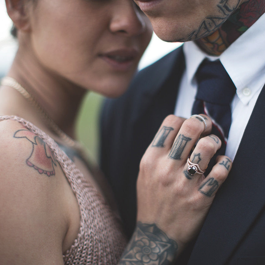 Wedding bands by Windfall Jewellery on tattooed couple.
