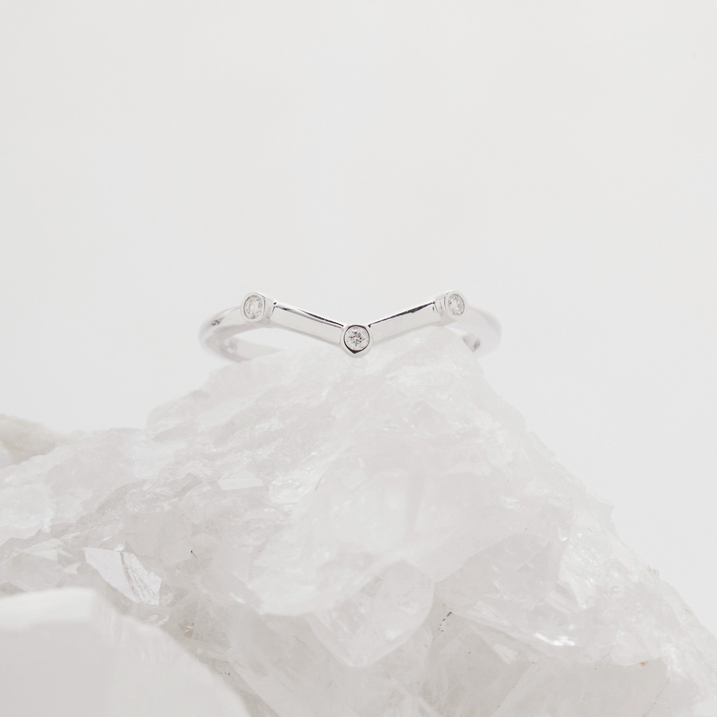 Chevron_shaped_wedding_band_with_flush_bezel_set_diamonds