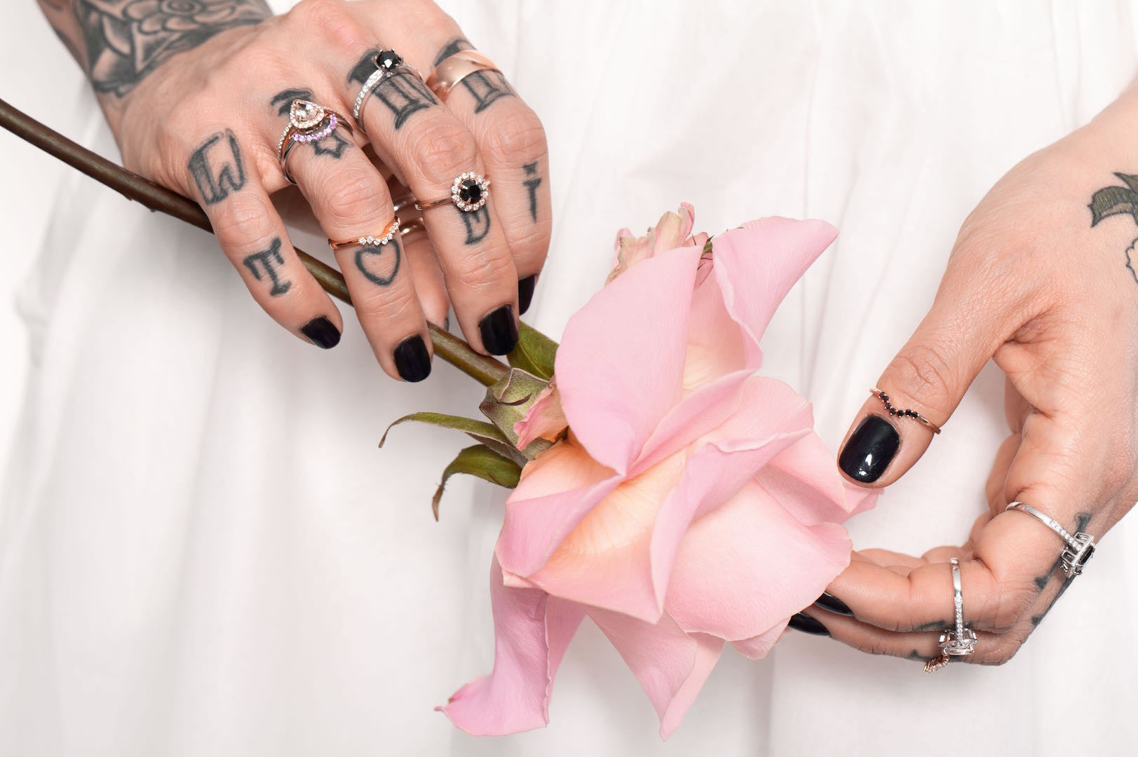 Oval floral halo diamond engagement ring in rose gold with sparkling cluster halo — classic bridal jewellery photographed on floral background.