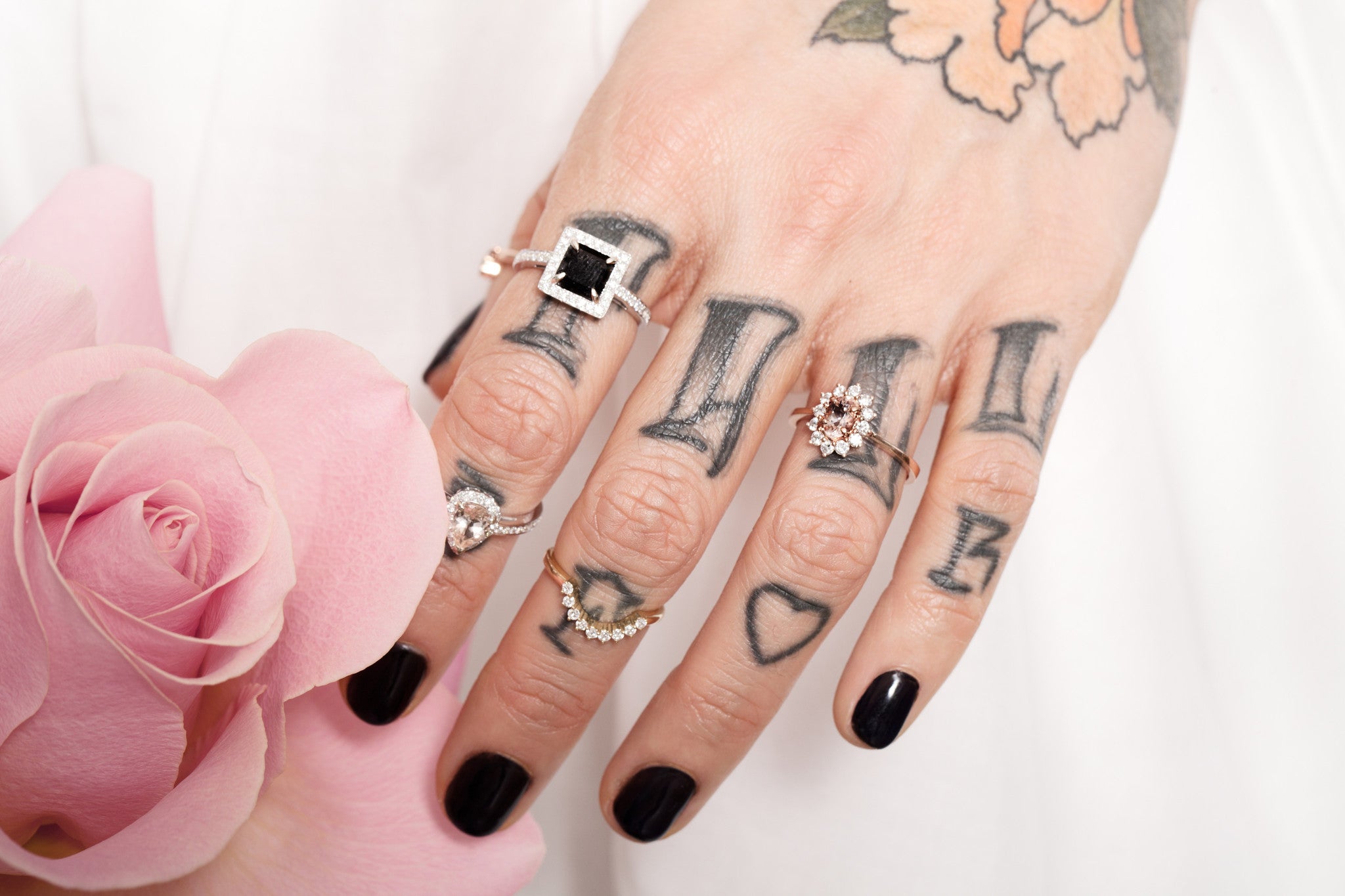 Oval floral halo diamond engagement ring in rose gold with sparkling cluster halo — classic bridal jewellery photographed on floral background.