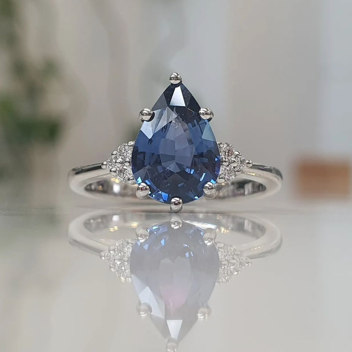 blue sapphire-ring-pear-cut-rose-gold-angled-view