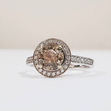 Rose gold halo diamond engagement ring with a thicker pavé band displayed on clean white background — romantic bridal jewellery photo