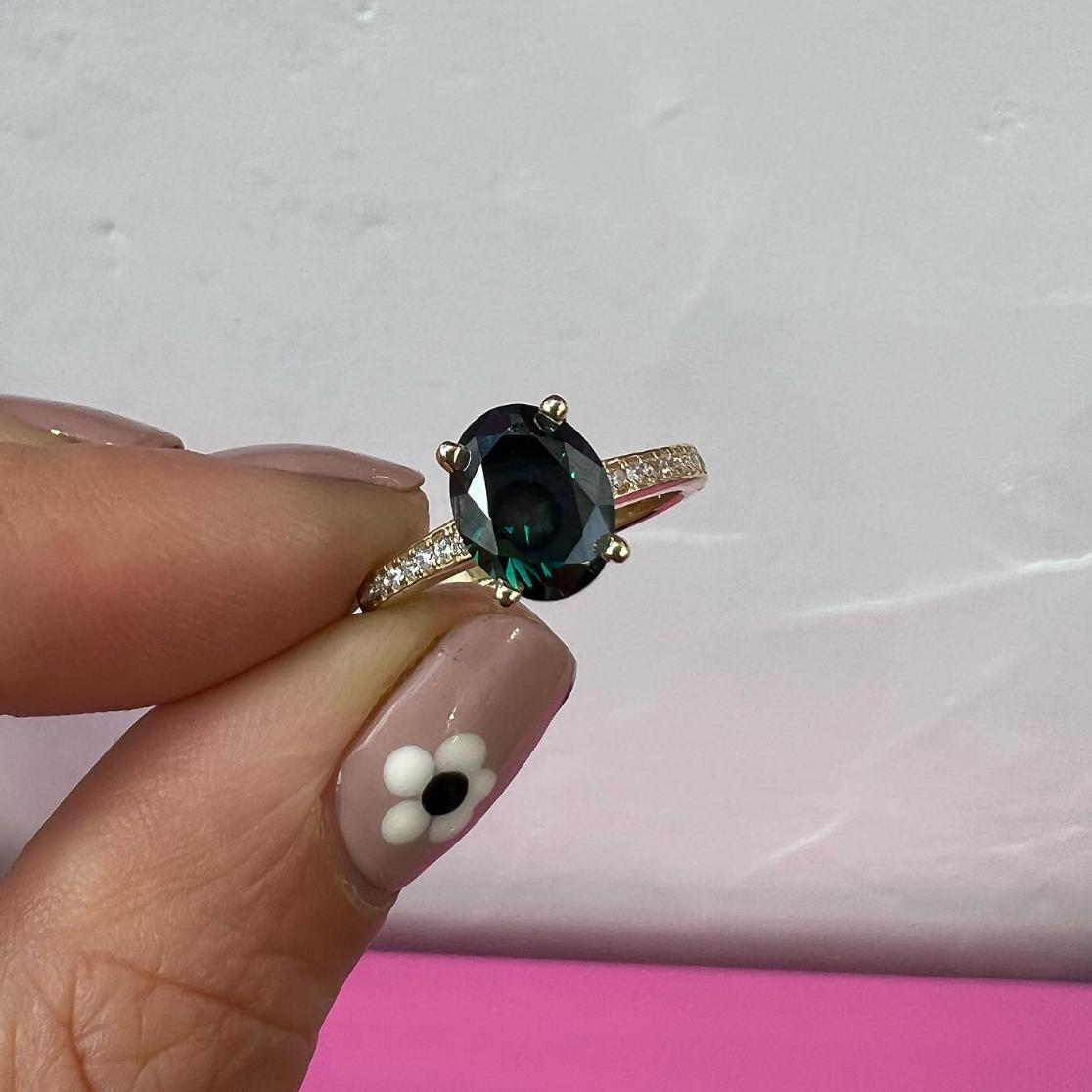 oval shaped sapphire on ring band with white diamonds