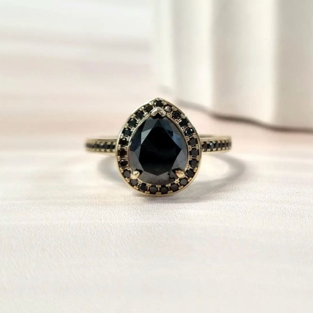 Black Diamond Pear halo diamond engagement ring paired with matching wedding band shown on white background — classic bridal set in white gold