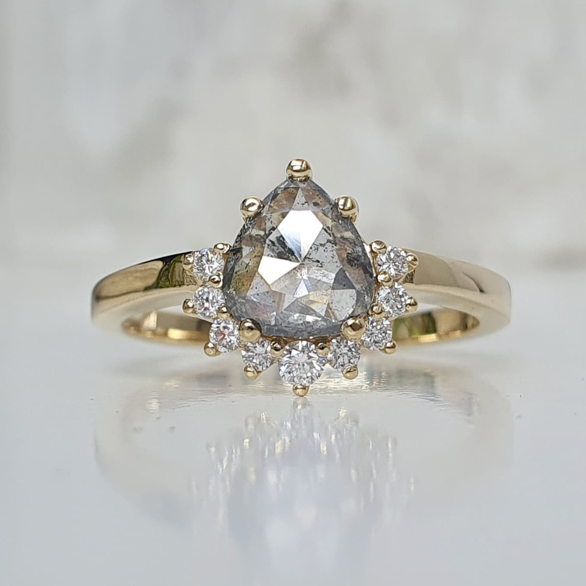 pear amina engagement ring with half halo of white diamonds