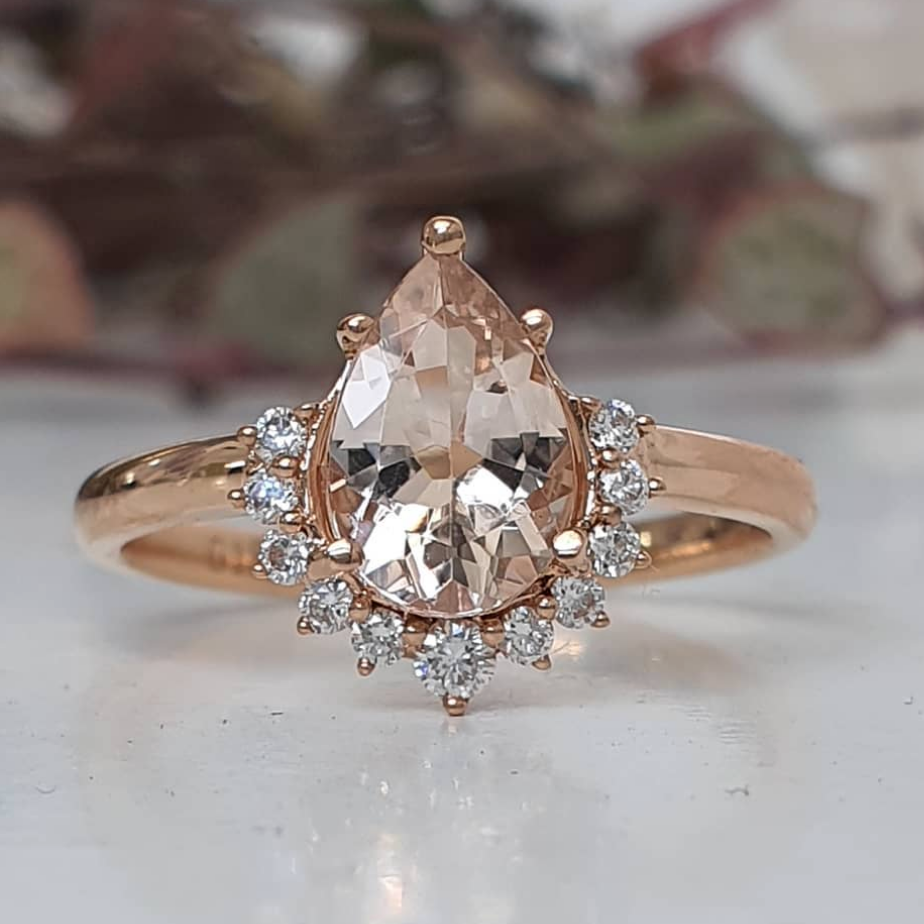 pear amina engagement ring with half halo of white diamonds