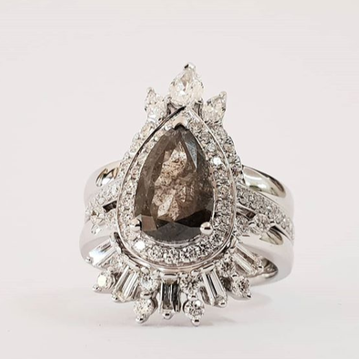 Salt and Pepper Pear halo diamond engagement ring paired with matching wedding band shown on white background — classic bridal set in white gold