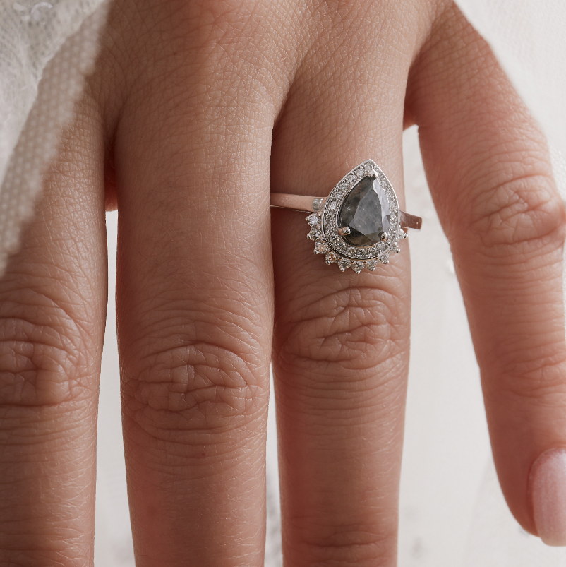 salt and pepper diamond pear shaped engagement ring white gold on brides hand