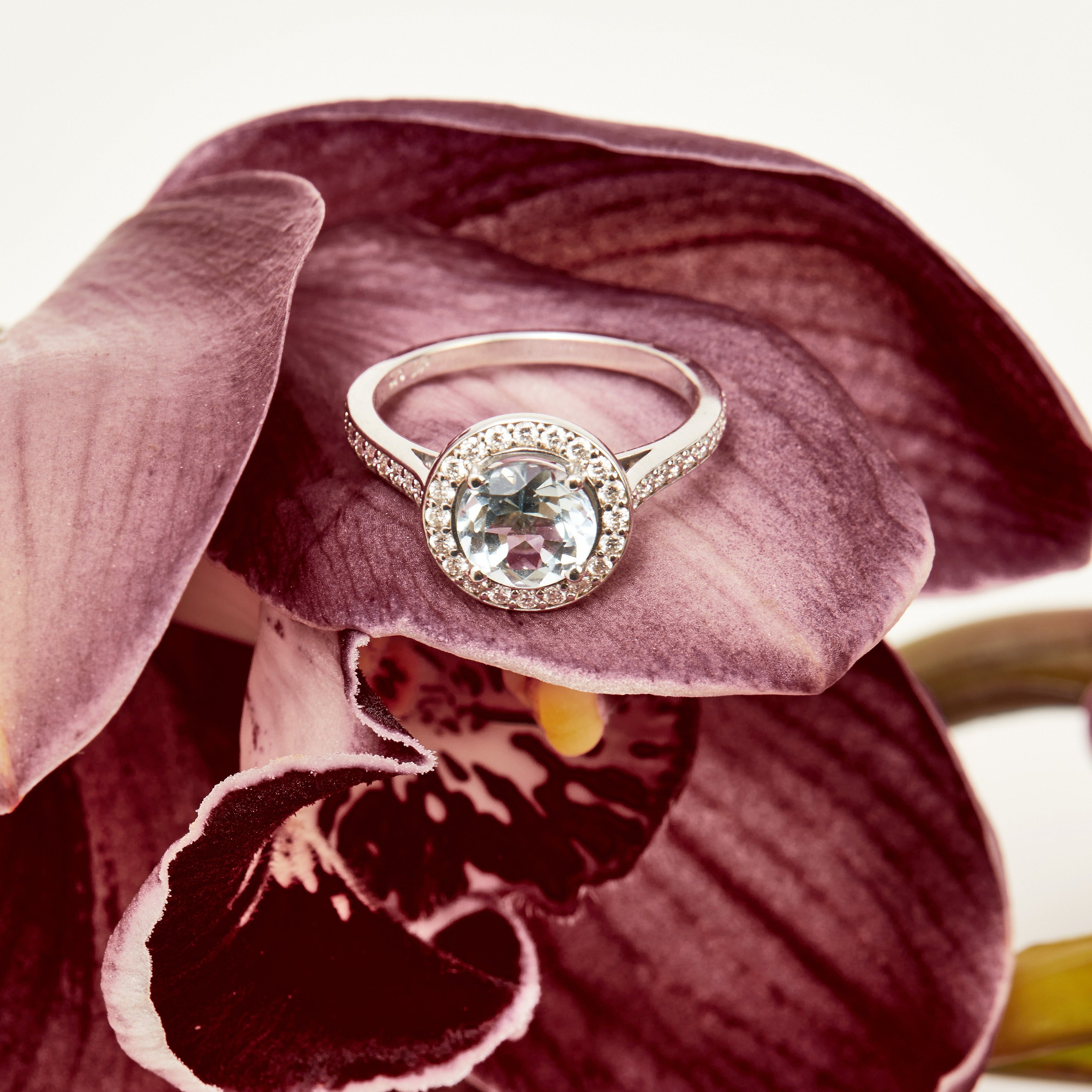 Elegant aquamarine engagement ring set in white gold with diamond halo