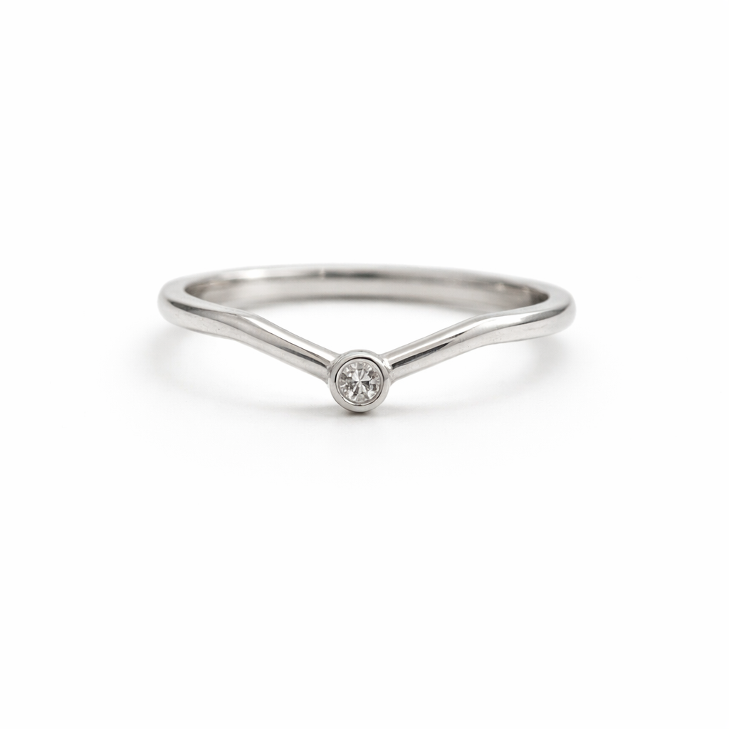 chevron shaped wedding band with white diamond at the tip