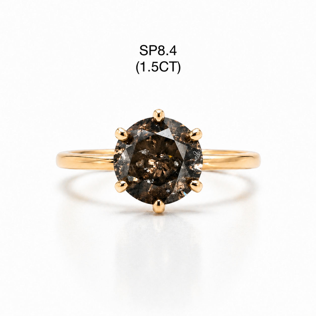 Gold ring with a champagne 
diamond on a white background