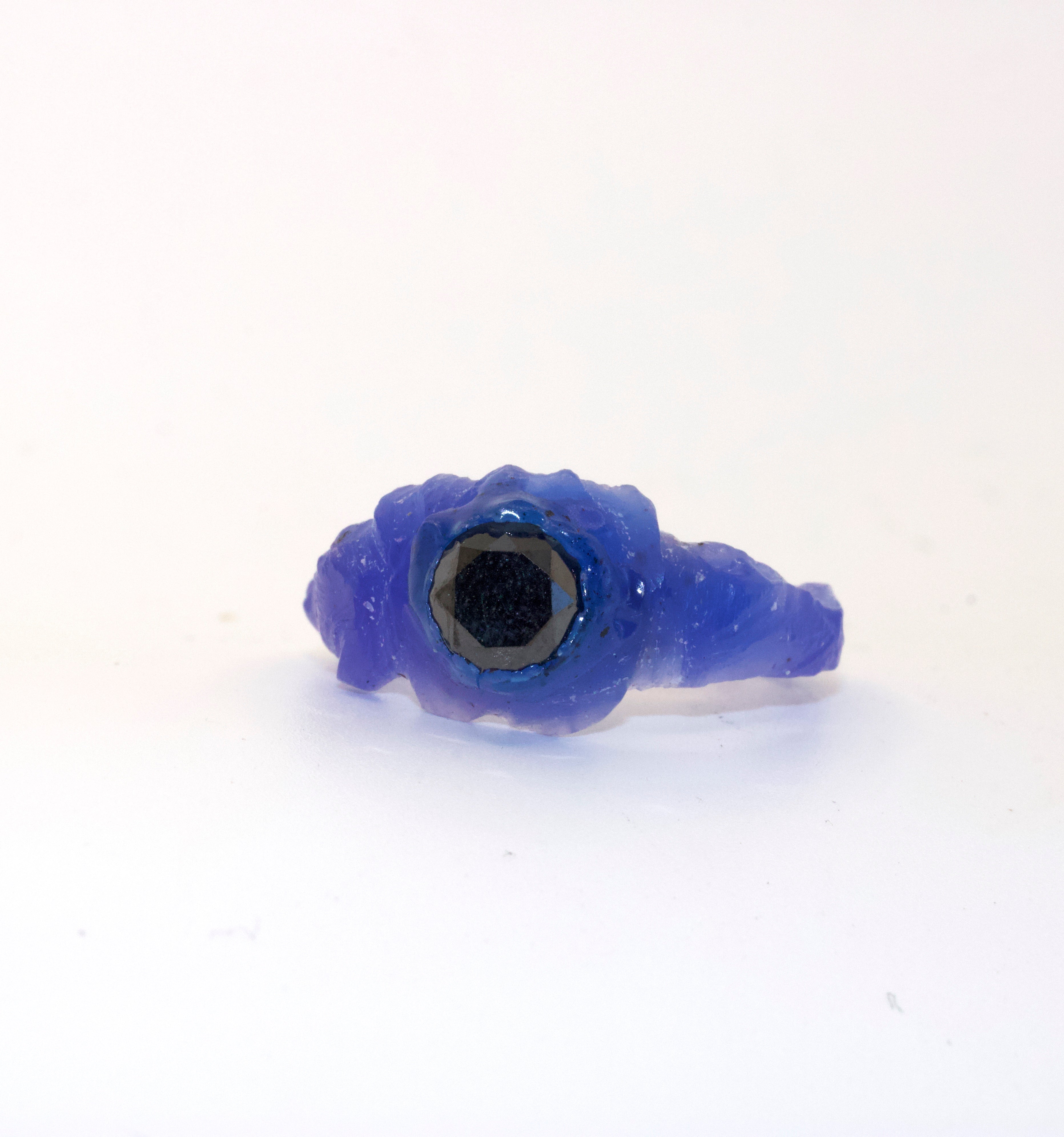 blue wax model of a ring on white background