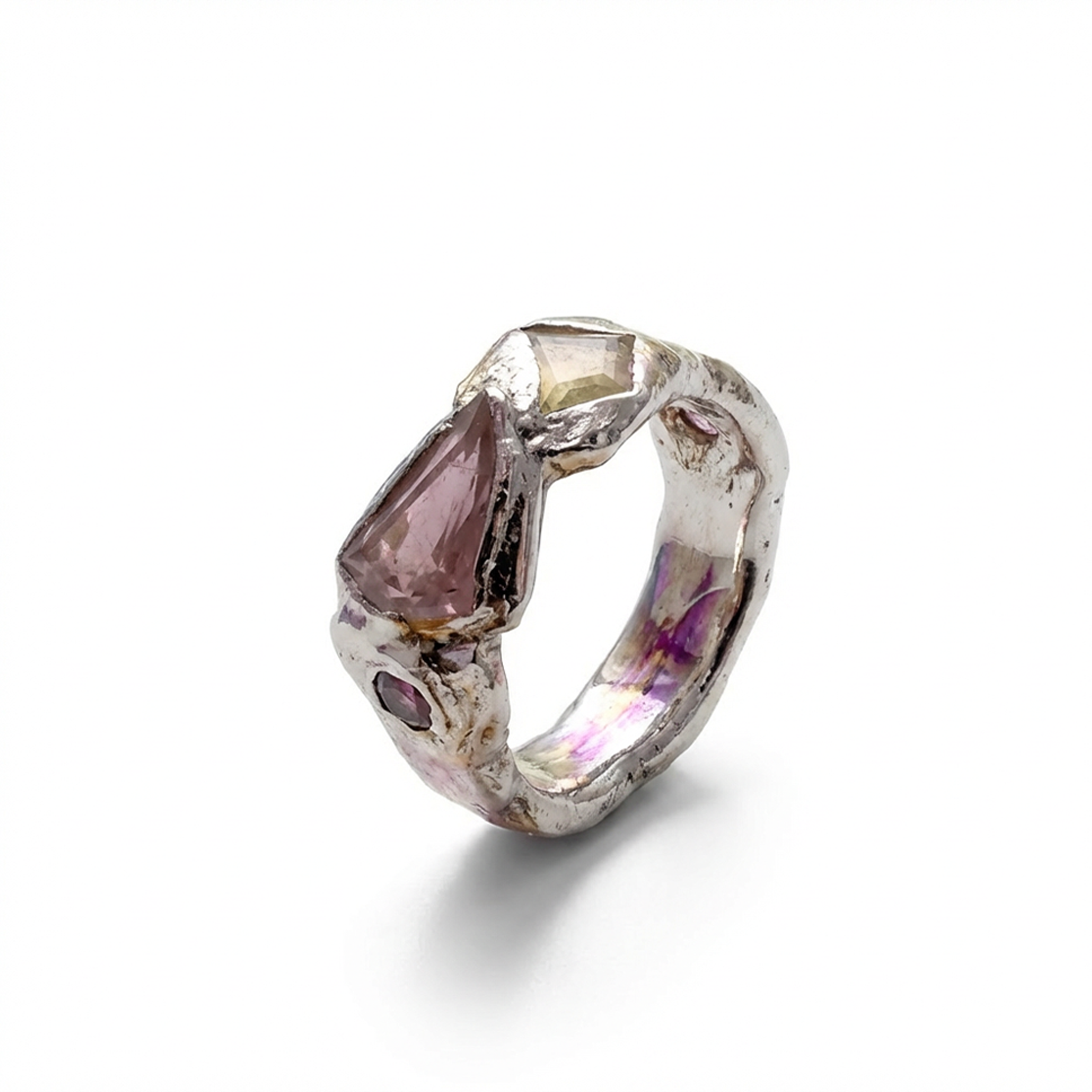 Silver ring with a pink gemstone on a white background