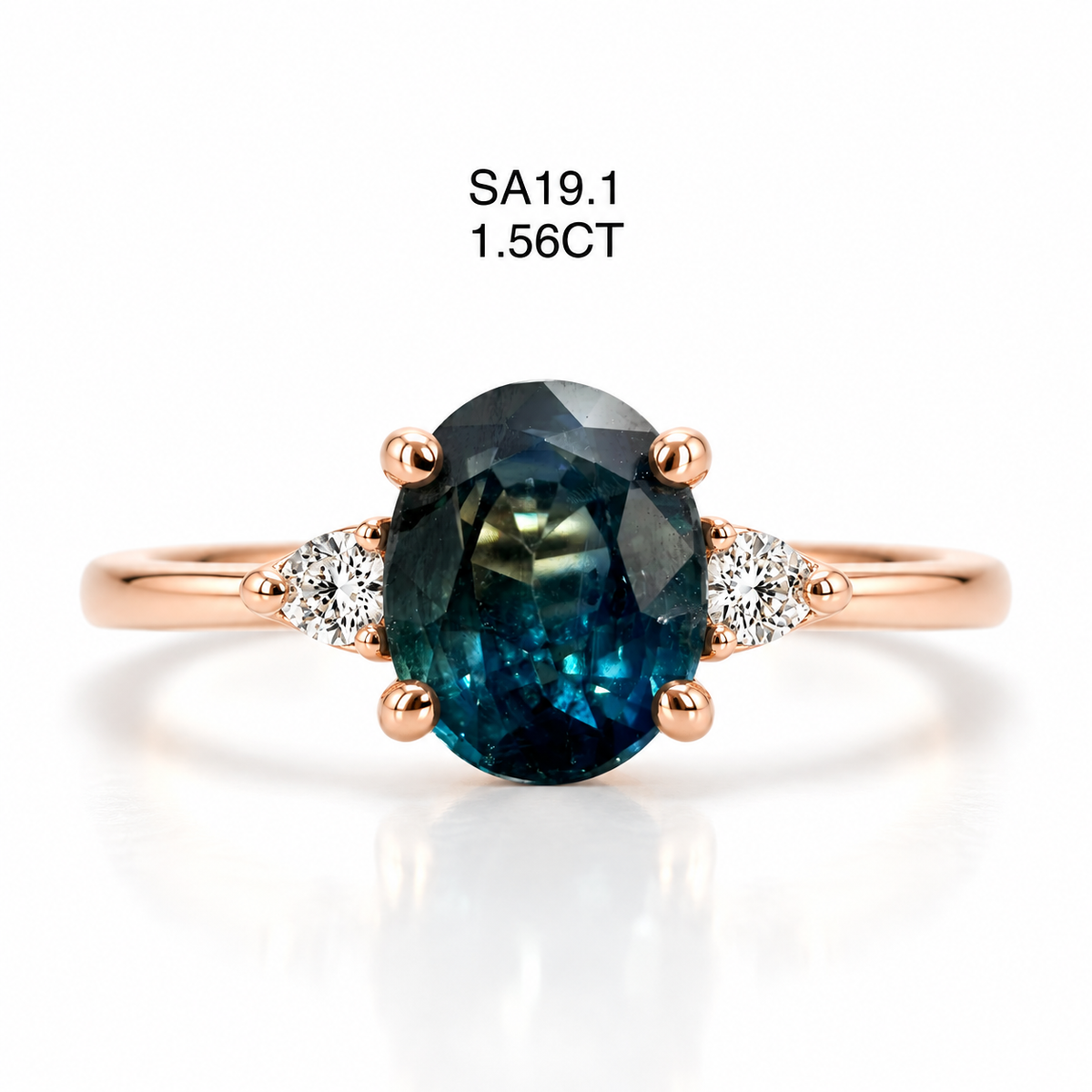 An oval-cut dark blue sapphire ring in a rose gold setting, accented with small round-cut diamonds on either side of the band. The text 'SA19.