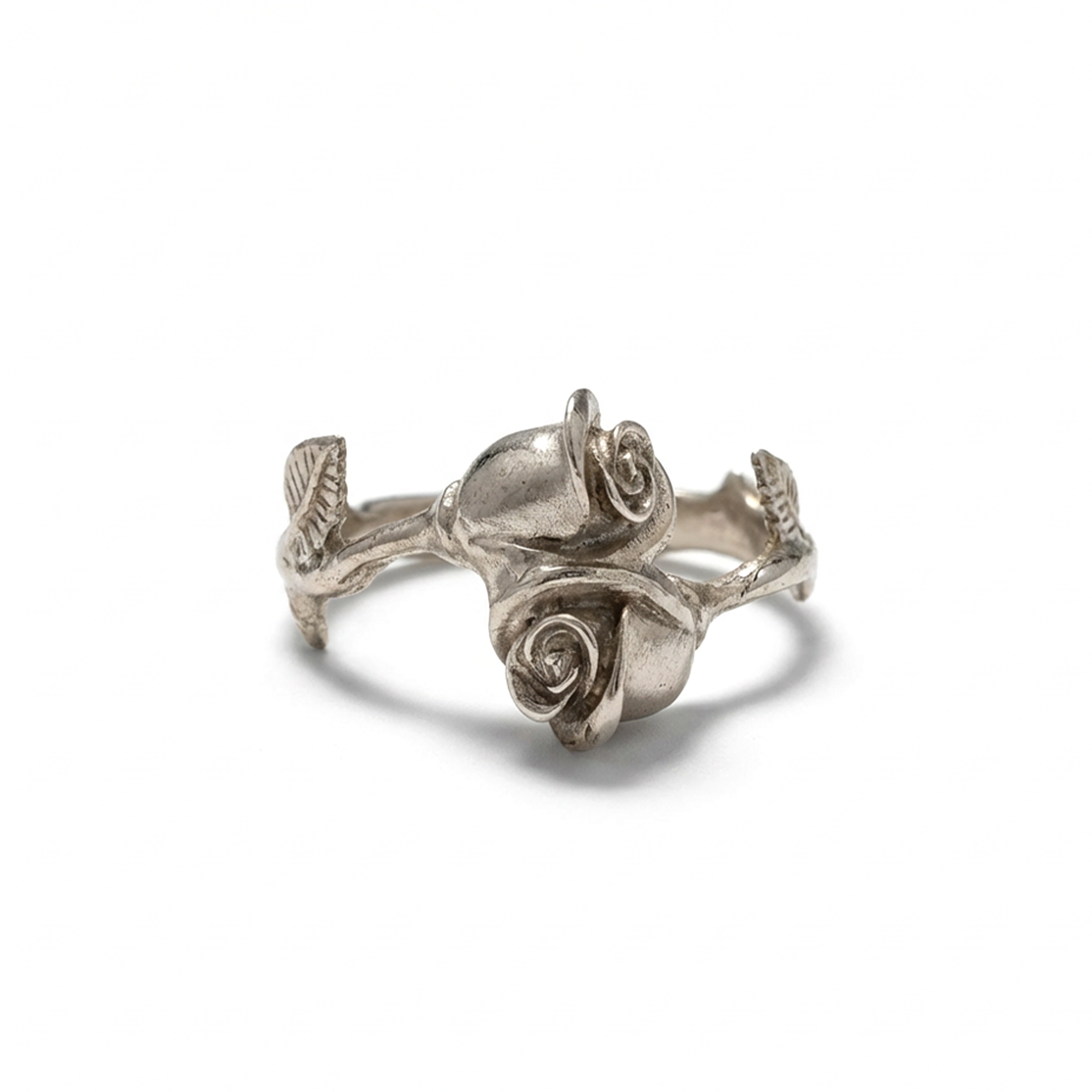 Silver rose-shaped ring on a white background