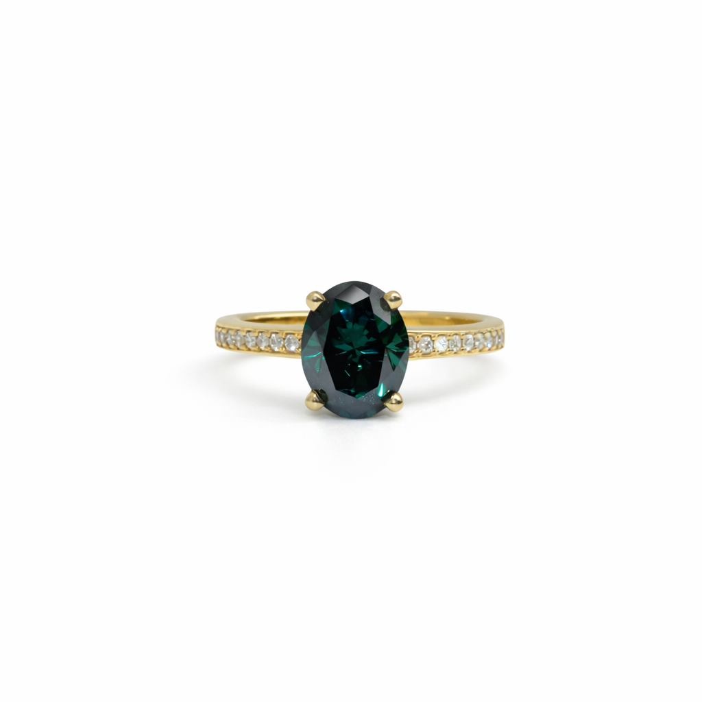Gold ring with a green gemstone on a white background