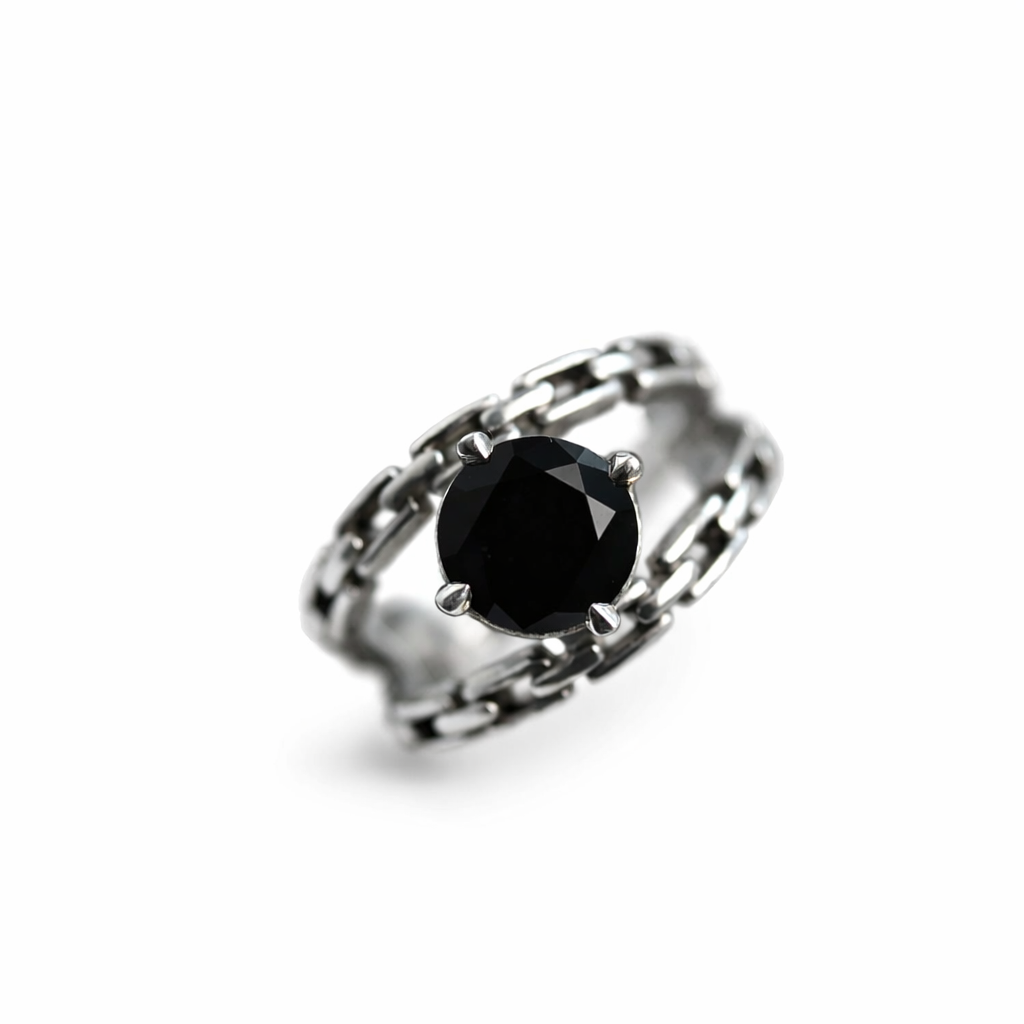 Silver ring with a black gemstone on a white background