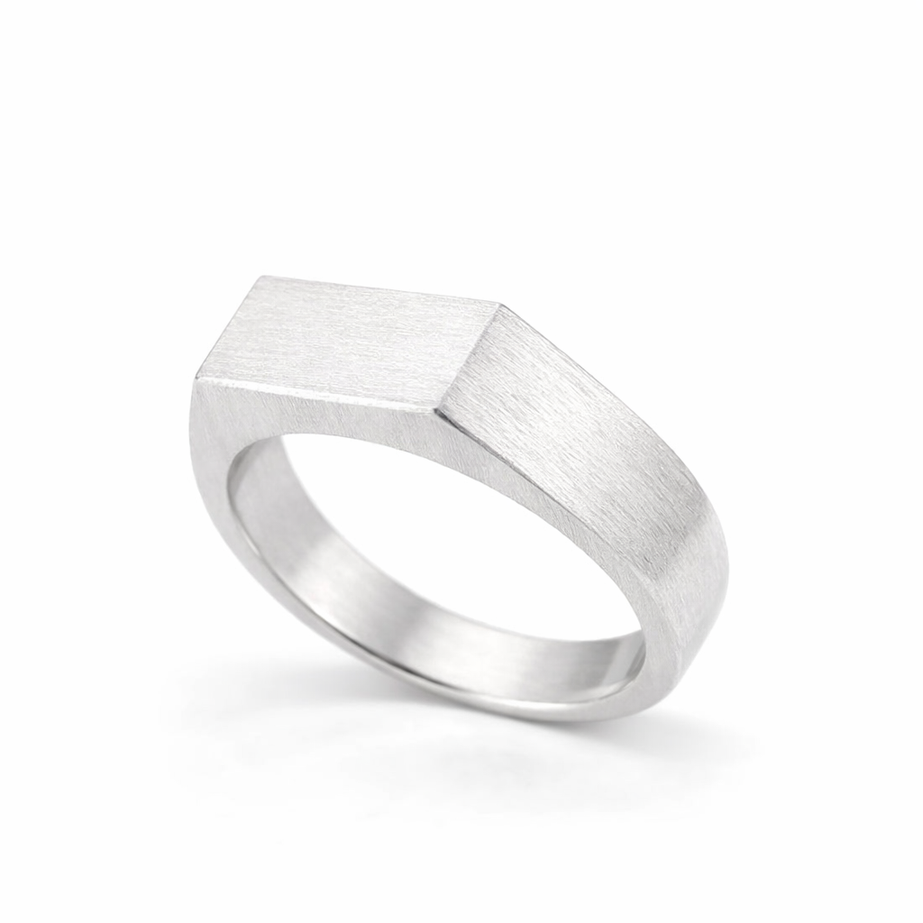 Silver ring with geometric design on a white background