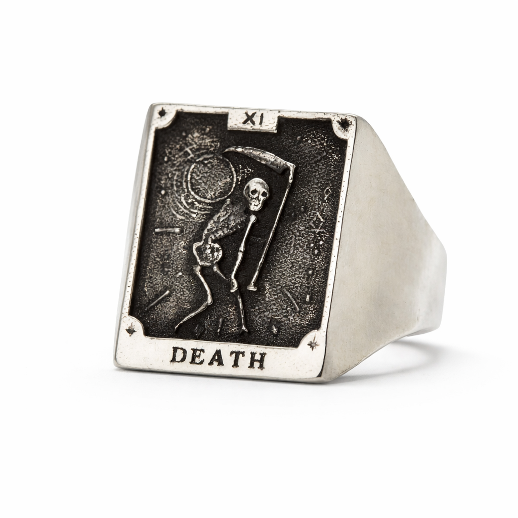 Silver ring with 'Death' card design featuring a skeleton and hourglass on a white background