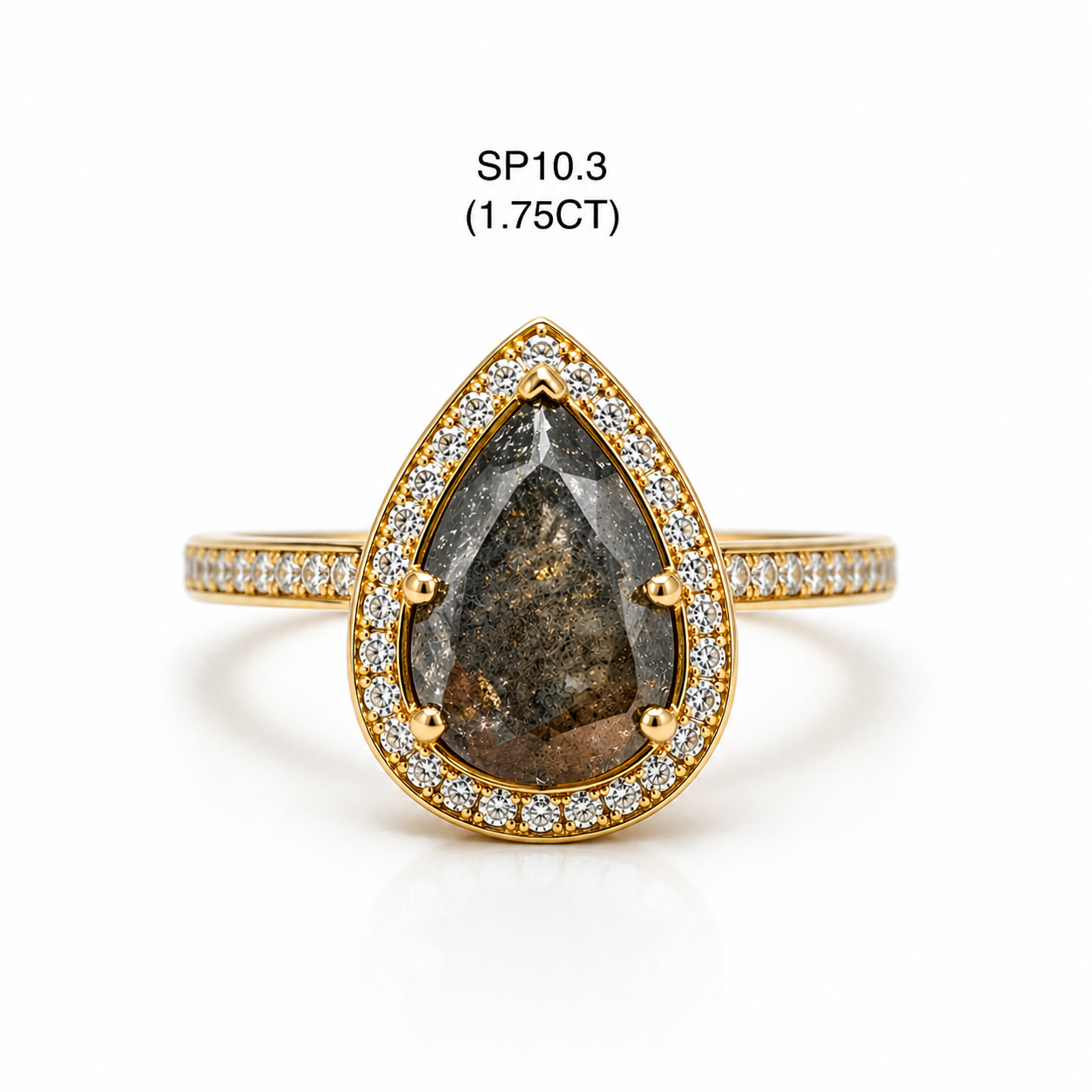 Gold ring with a large teardrop-shaped stone and smaller stones on a white background
