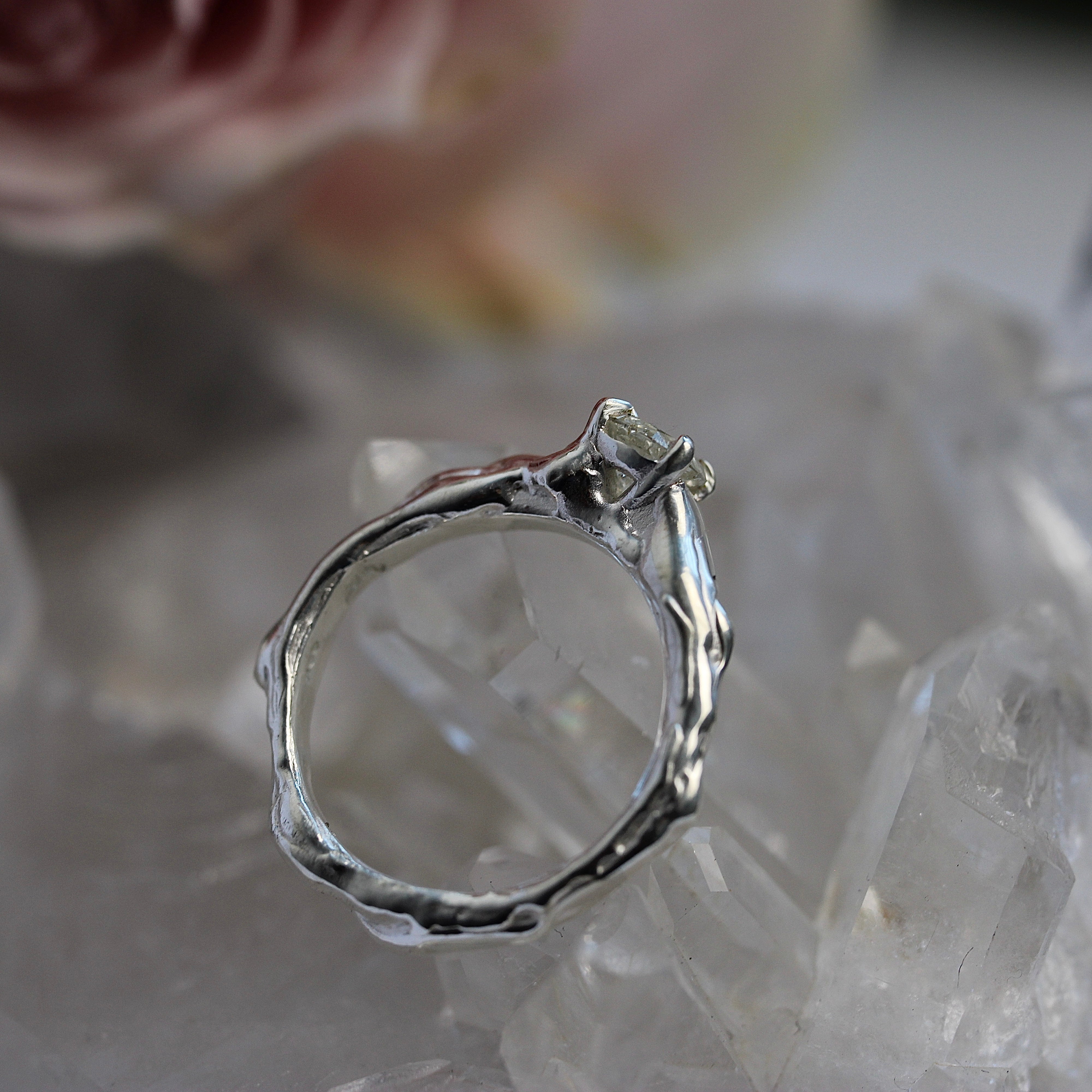 Silver ring with a diamond on a crystal surface