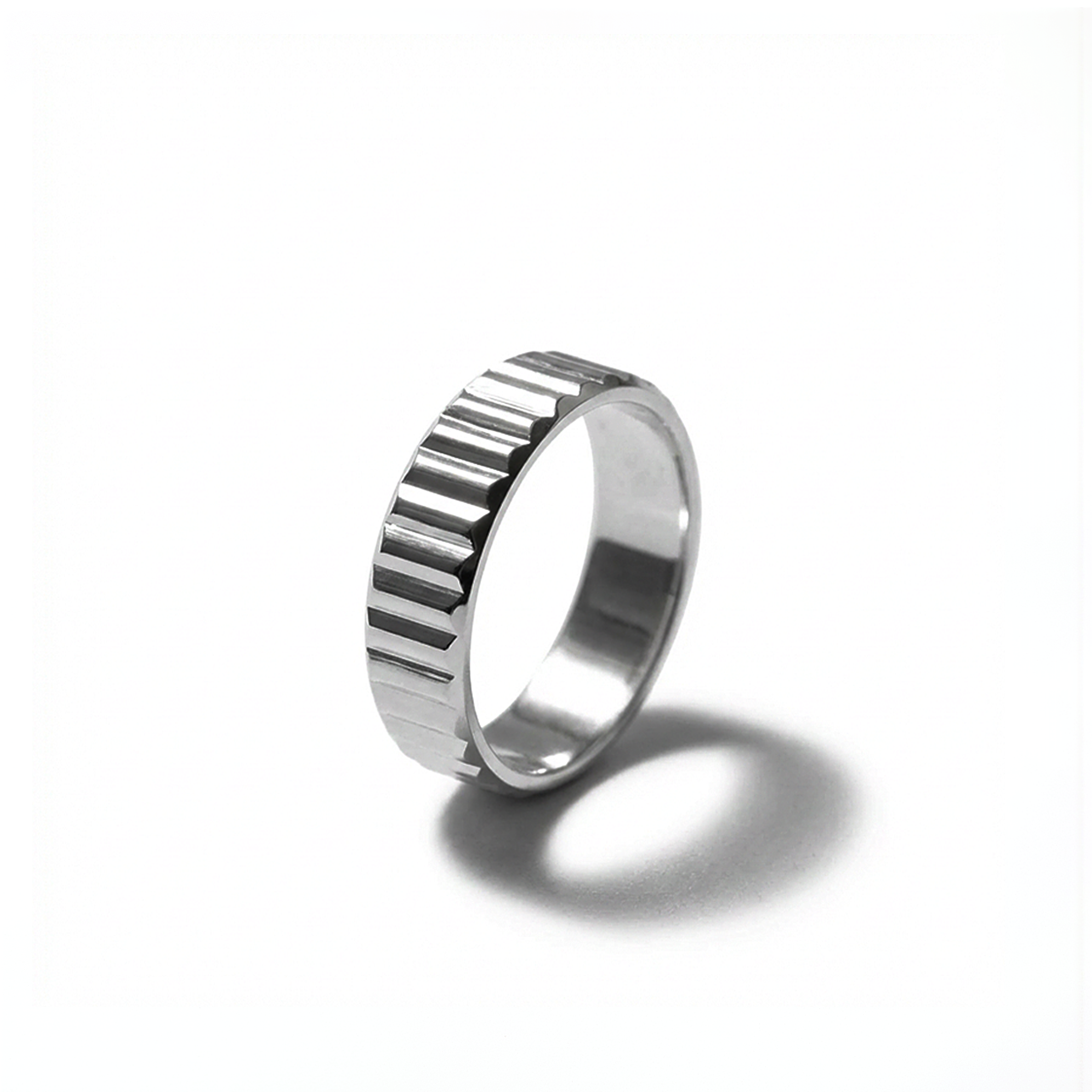 Silver ring with a textured band on a white background