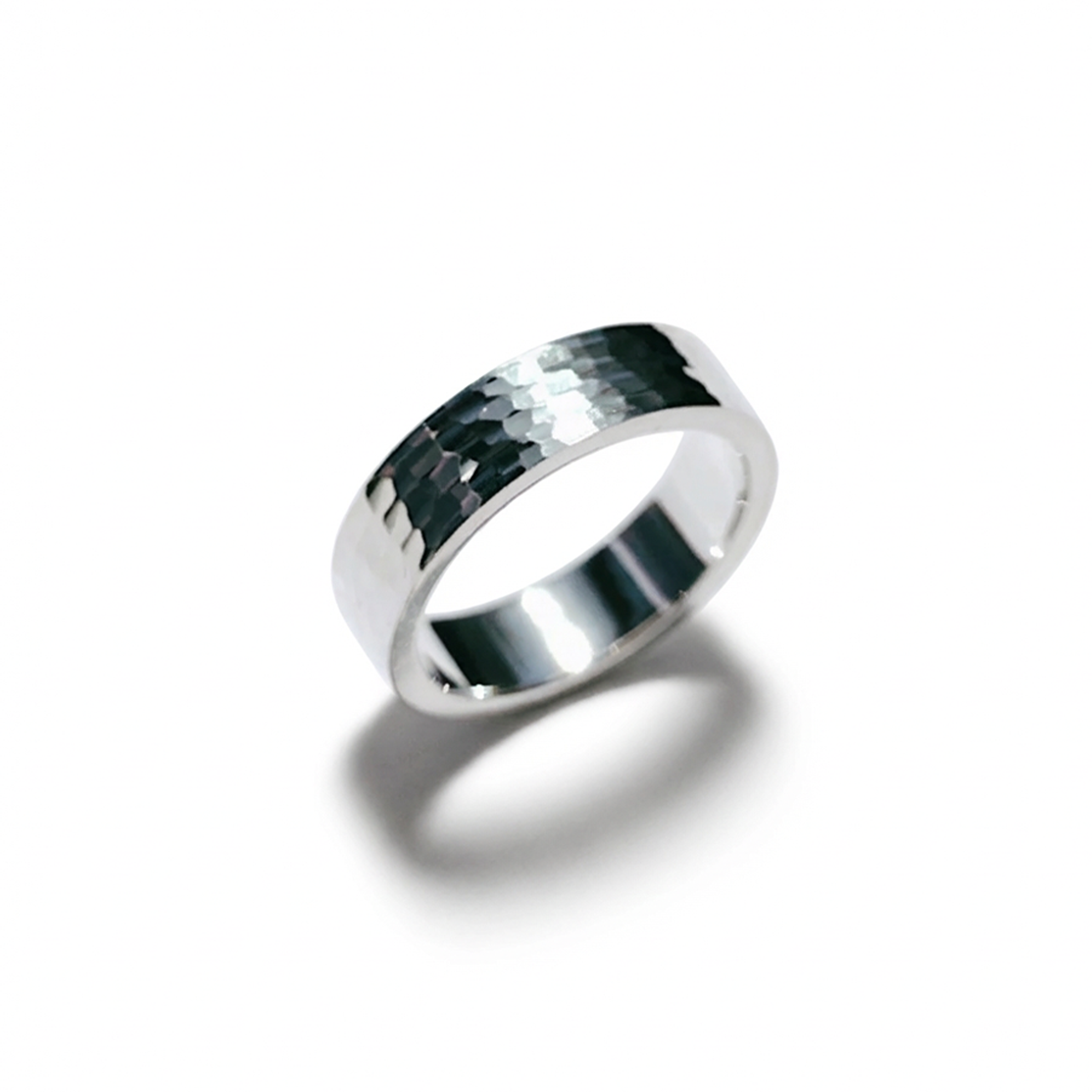 Silver ring with a textured band on a white background
