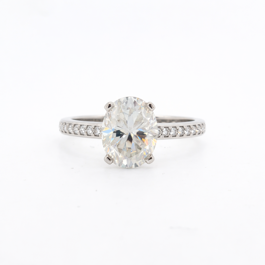 Diamond ring with a large central gemstone and smaller stones on a white background