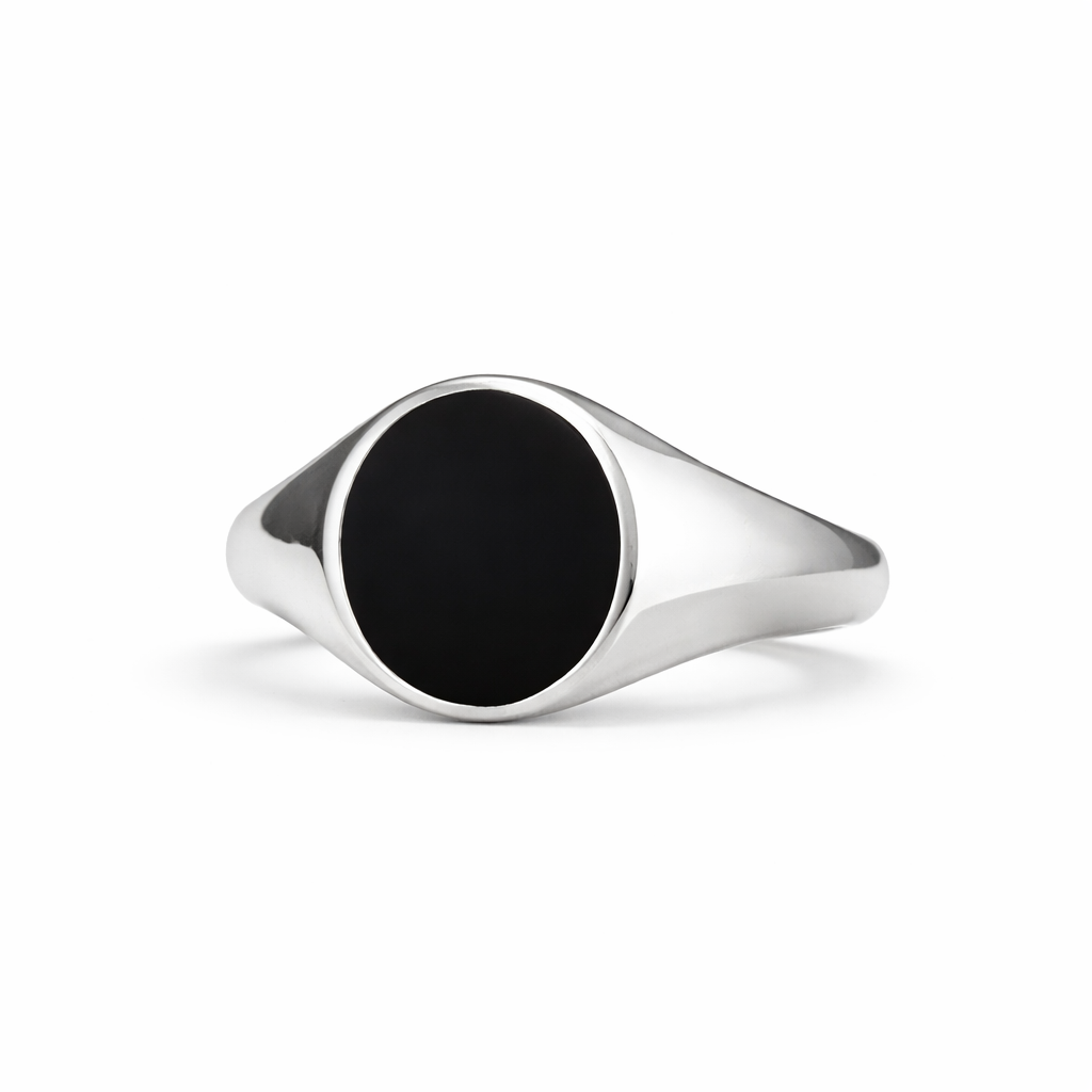 Silver signet ring with a black stone on a white background