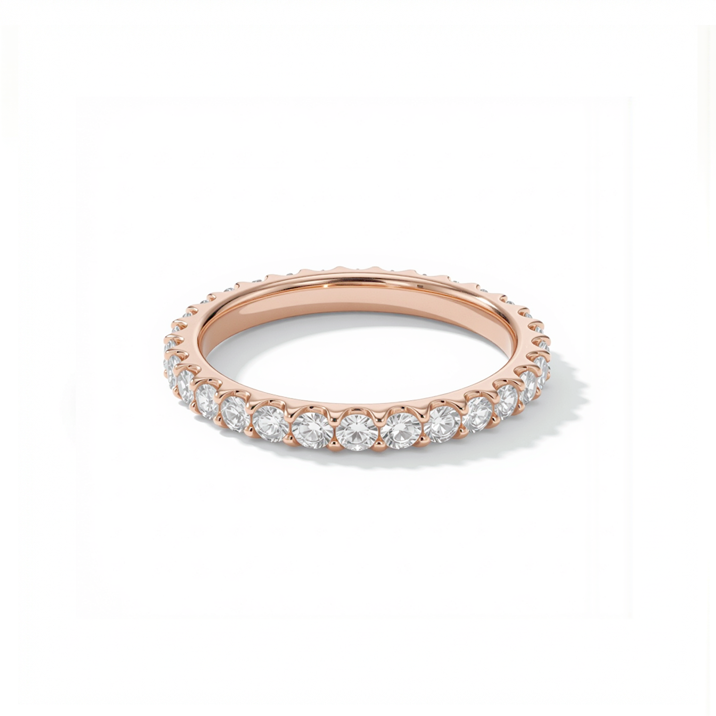 Rose gold ring with diamonds on a white background