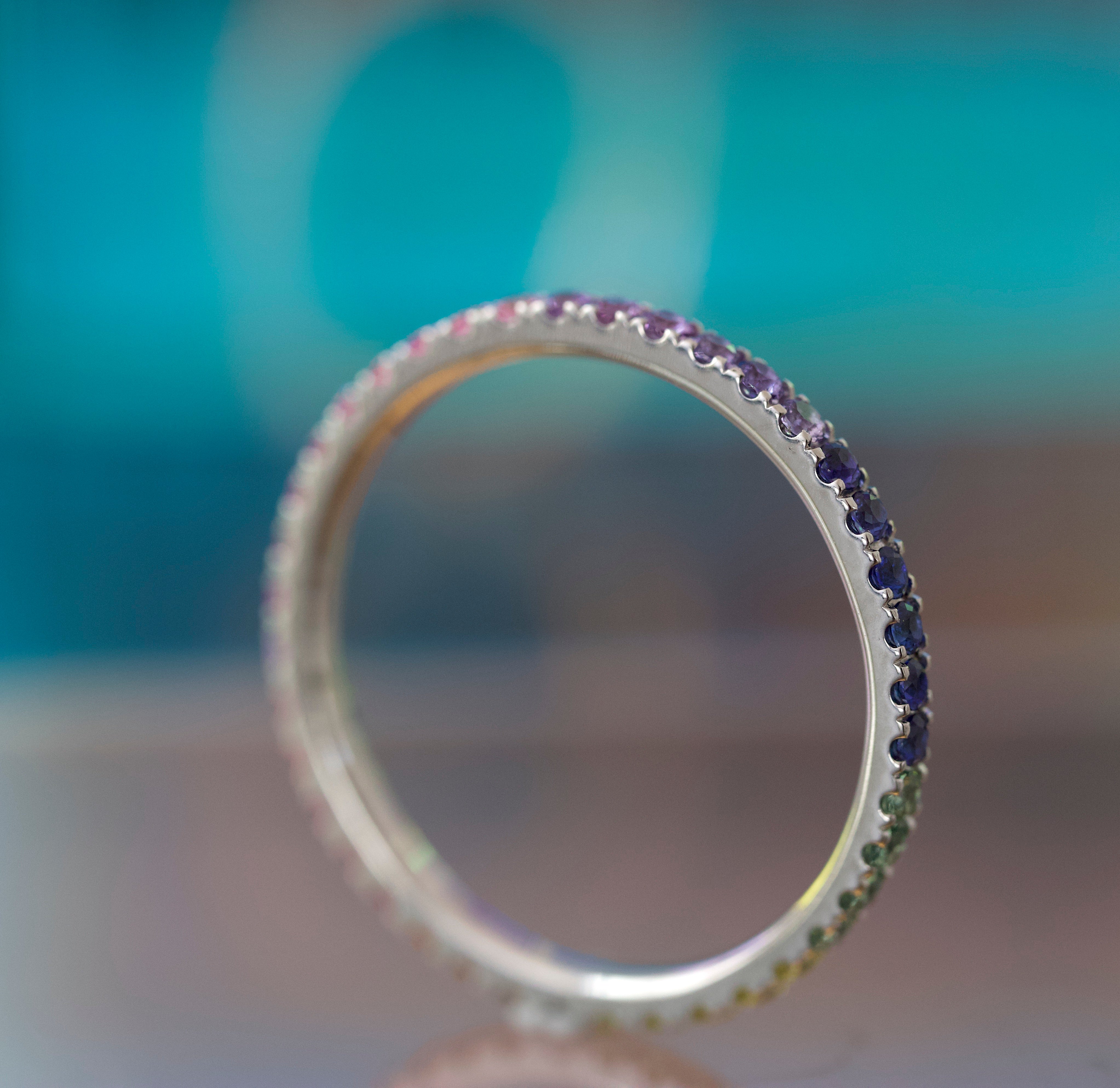 Close-up of a silver ring with gemstones against a blurred background