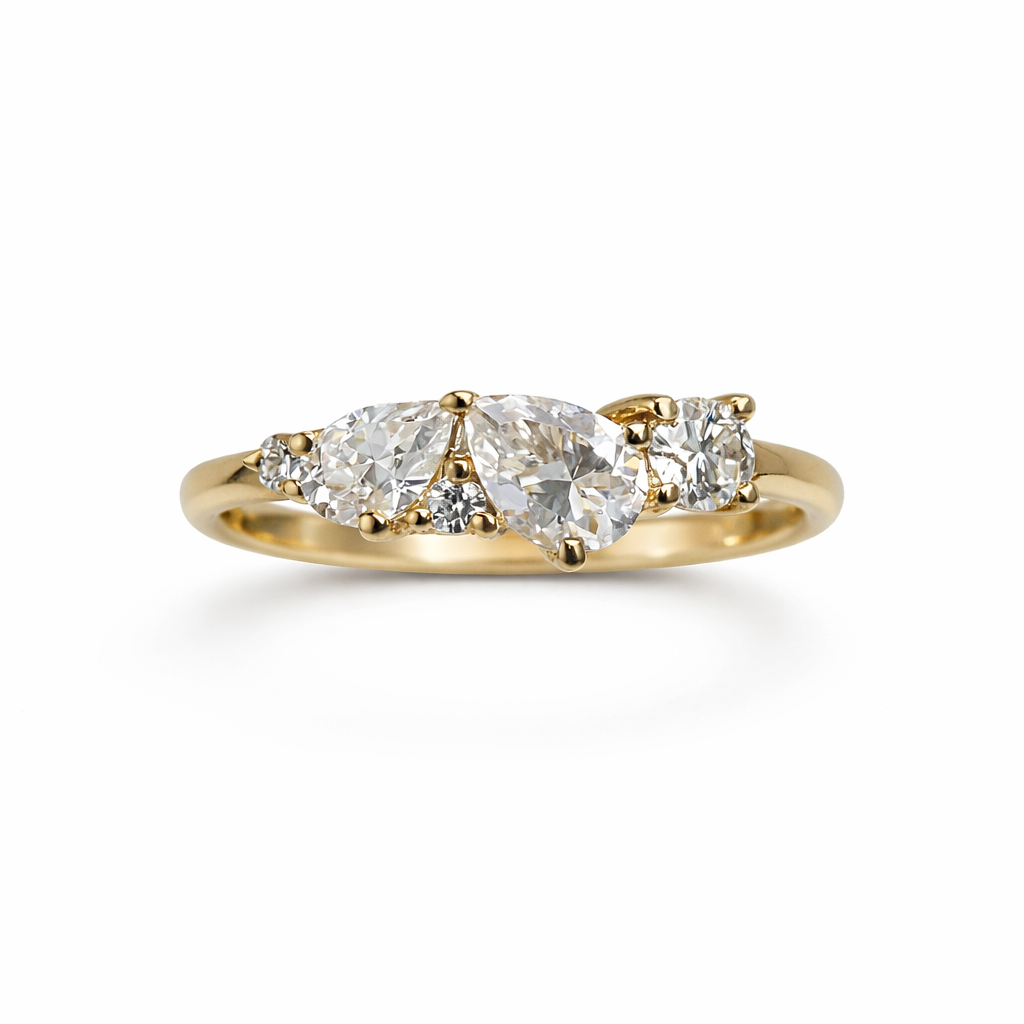 Gold ring with three pear-shaped diamonds on a white background