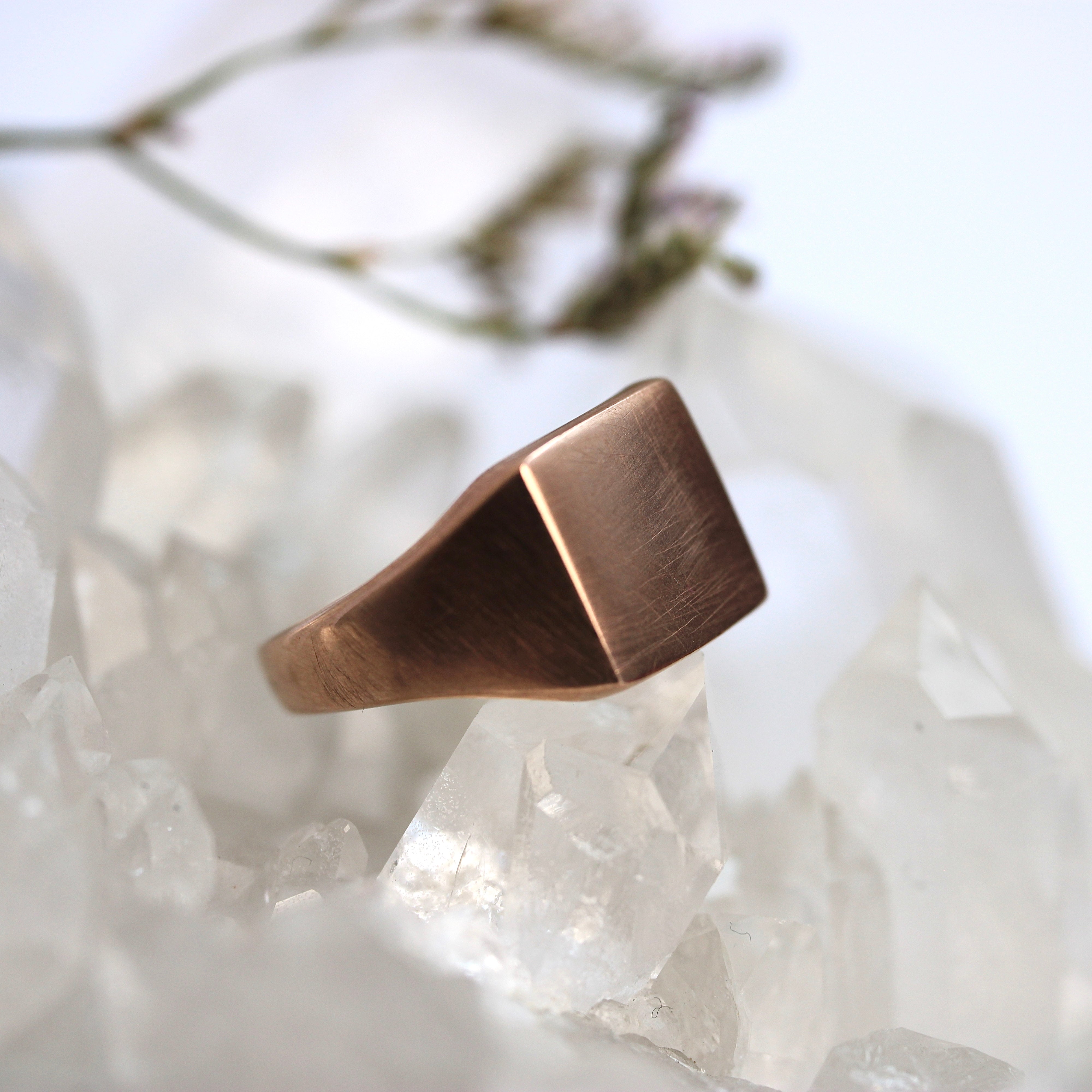 Rose gold ring on a crystal background