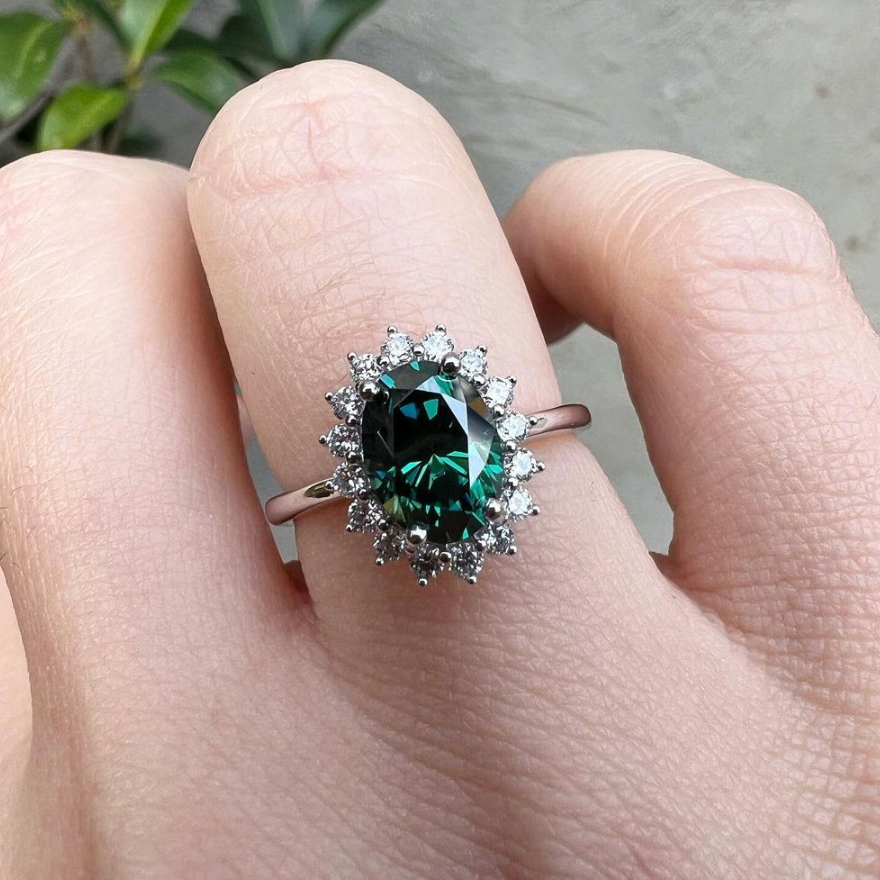 Oval floral halo diamond engagement ring in rose gold with sparkling cluster halo — classic bridal jewellery photographed on hand windfall jewellery