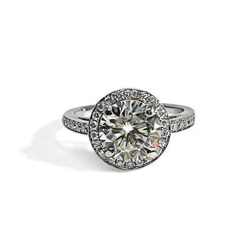 Round halo diamond engagement ring in yellow gold with a thicker pavé band, photographed on a clean white background — elegant bridal jewelry