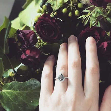 Rose gold halo diamond engagement ring with a thicker pavé band displayed on hand — romantic bridal jewellery photo