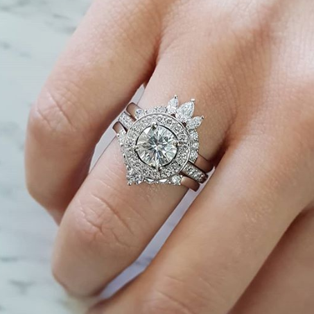 Round halo diamond engagement ring in yellow gold with a thicker pavé band, photographed on a clean white background — elegant bridal jewelry