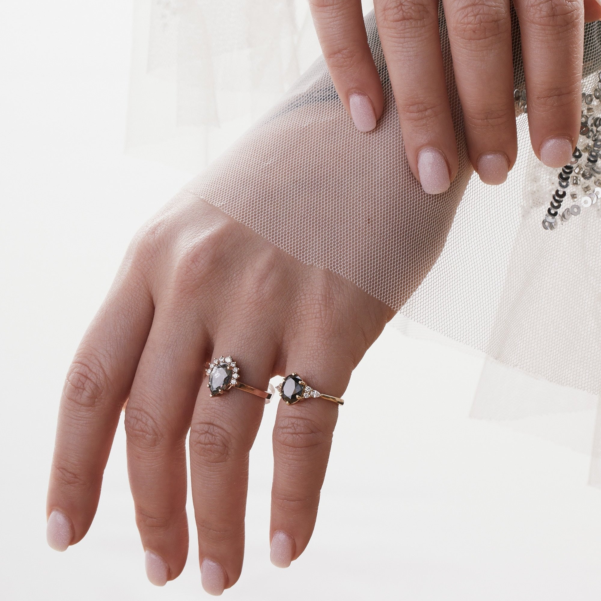 pear amina engagement ring with half halo of white diamonds