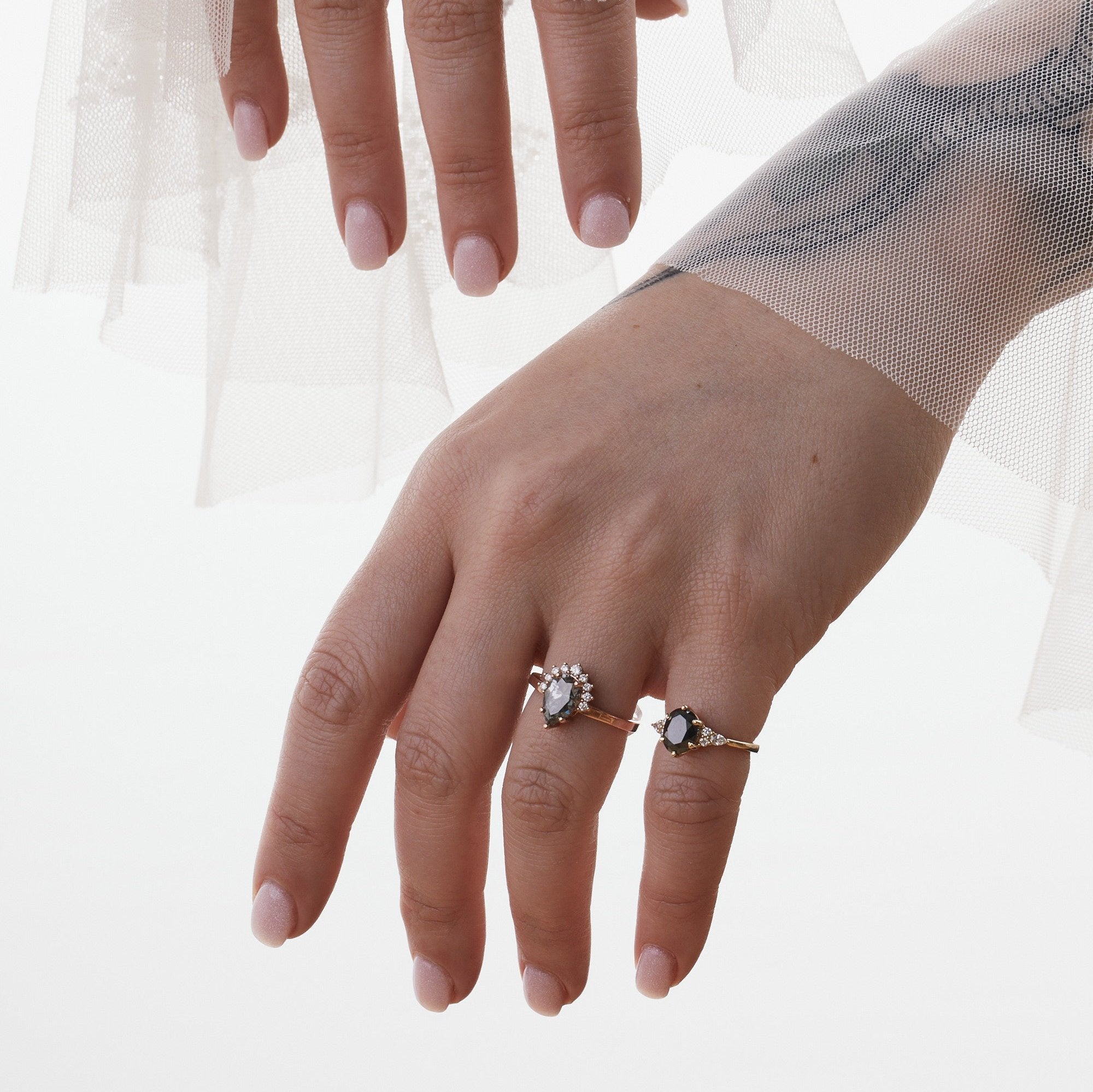 pear amina engagement ring with half halo of white diamonds