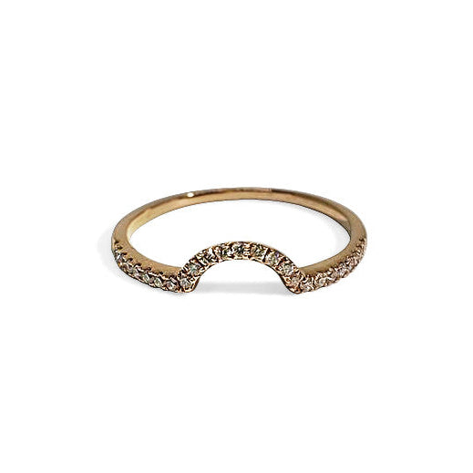 A white gold stacker band with round white diamonds set in a curved pattern, creating a halo effect when worn alongside an engagement ring.